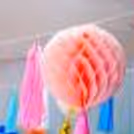 An array of rosettes and pom poms in lively colours, add to the festive ambience.