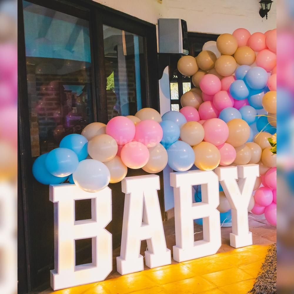 The balloon wall, a focal point of the decor, invites guests to a whimsical journey of celebration.