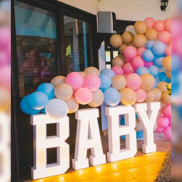 The balloon wall, a focal point of the decor, invites guests to a whimsical journey of celebration.