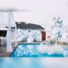 Dive into the charm of our Aqua Bliss baby shower decor featuring a Balloon Wall with a Stand in soothing pastel blue hues and adorable macaron balloons.