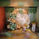 A delightful surprise baby shower setup featuring a Ring Stand adorned with pastel peach flex,