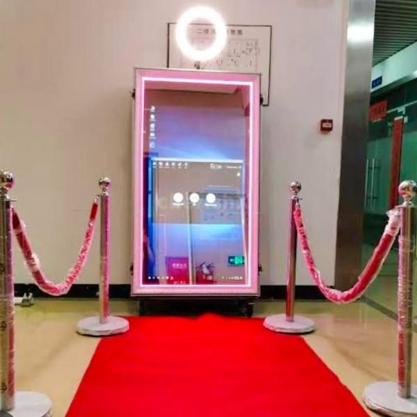 Enchanting Magic Mirror Instant Photobooth setup with a 7 ft tall mirror and a red carpet for an exclusive feel.