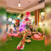 A captivating glimpse of Love Garden's enchanting picnic setup, adorned with dreamy balloon arrangements and a warm love neon sign.