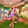 A captivating glimpse of Love Garden's enchanting picnic setup, adorned with dreamy balloon arrangements and a warm love neon sign.