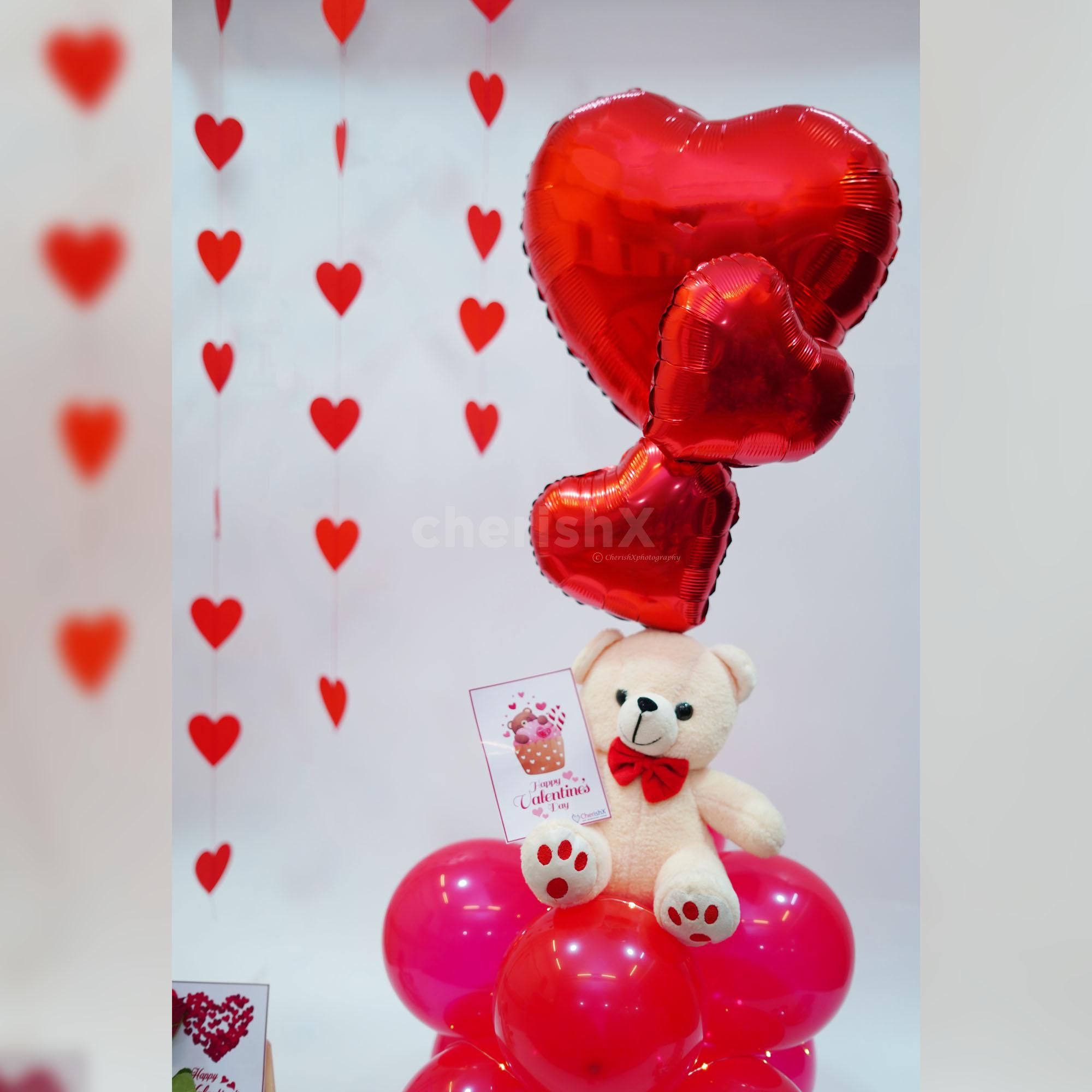 Bright red balloon stand, adding a festive and uplifting touch to the surprise.