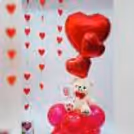 Bright red balloon stand, adding a festive and uplifting touch to the surprise.