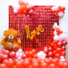 A romantic Valentine's Day setting with pastel pink, pink chrome, and red balloons,