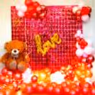 An enchanting Valentine's decor arrangement with a mix of balloons with a warm LED light.