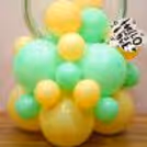 A balloon bouquet featuring 25 Apricot Vintage and Pastel Green Balloons