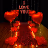 A romantic Valentine decor adorned with Rose Petals, Red Heart Balloons, and Lights