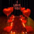 A romantic Valentine decor adorned with Rose Petals, Red Heart Balloons, and Lights