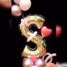A Pretty customized initial adorned with a delicate pink bow ribbon