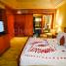 Romantic in-room décor with candles and flower petals for Valentine’s Day