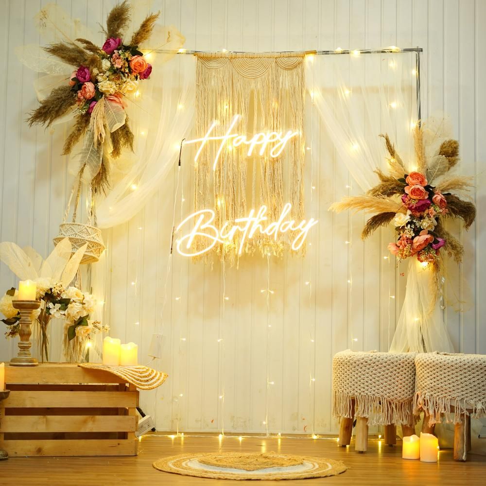 Captivating birthday setup featuring a Rectangular Stand adorned with delicate white netting, Pixel Lights, and Artificial MultiColor Flowers.