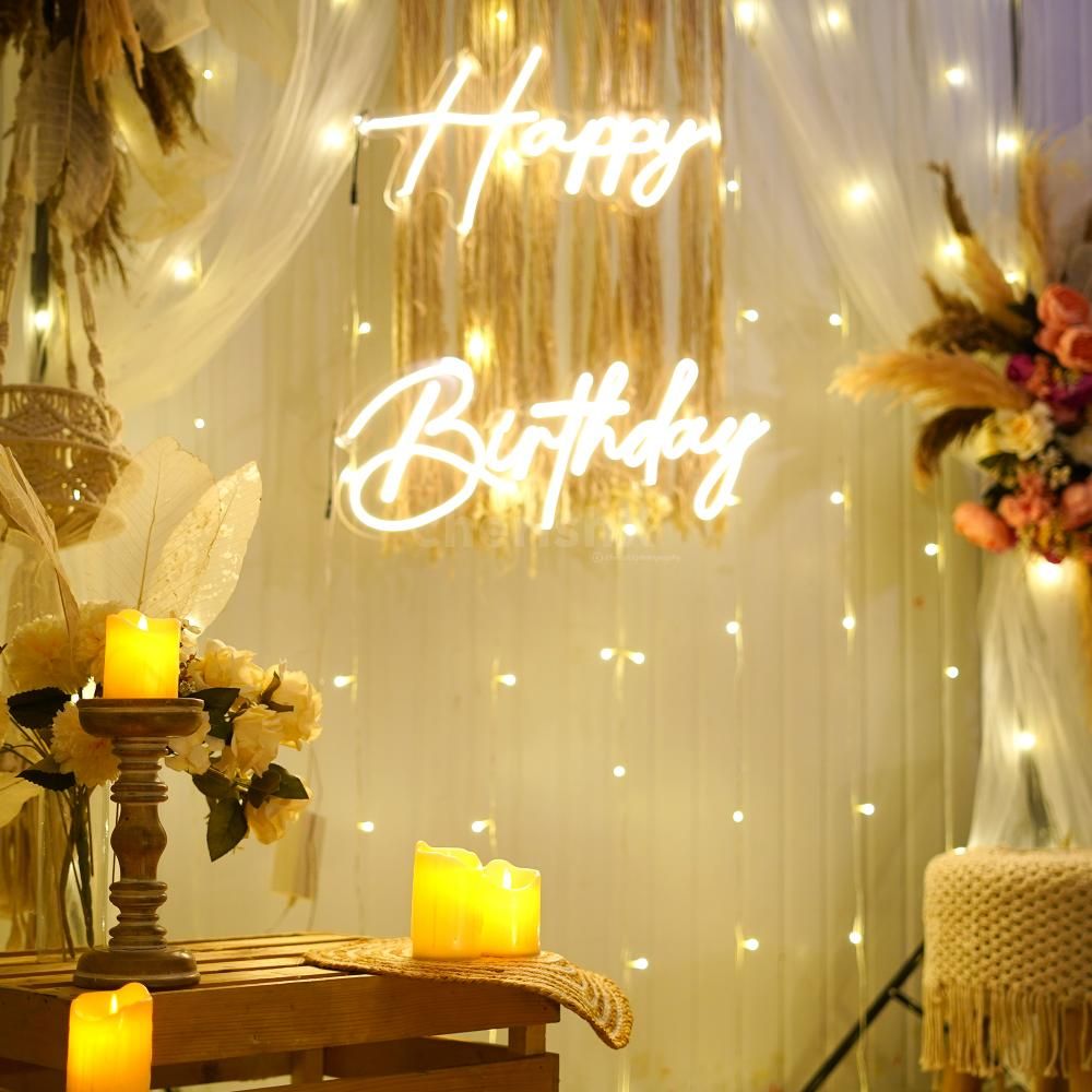 Elegantly decorated wooden candle stand with LED candles, surrounded by a jute mat, jute basket, and a vase boasting an artificial flower bunch and leaves."