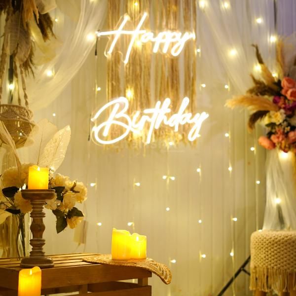 Elegantly decorated wooden candle stand with LED candles, surrounded by a jute mat, jute basket, and a vase boasting an artificial flower bunch and leaves."