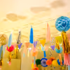 Close-up of colourful honeycomb balls adorned with festive tassels.