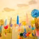 Close-up of colourful honeycomb balls adorned with festive tassels.