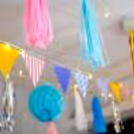 Close-up of colourful honeycomb balls adorned with festive tassels.