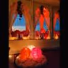 Step into an enchanting ambiance adorned with lacy curtains and fresh rose petals