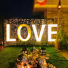 Illuminate your love story with neon declarations under the twilight sky.