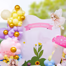 A mushroom cutout with gentle spots and pastel balloons creates woodland magic