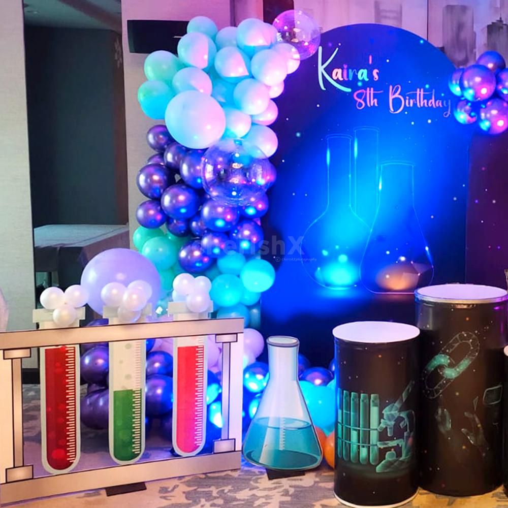 Elevate your celebration with the charm of scientific decorations and vibrant balloons.