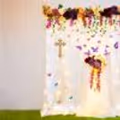 Capturing the sanctity of baptism in a garden of blooming flowers.