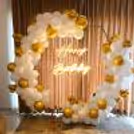Elegant white hexagon birthday neon backdrop decor, creating a stylish and modern celebration setup.