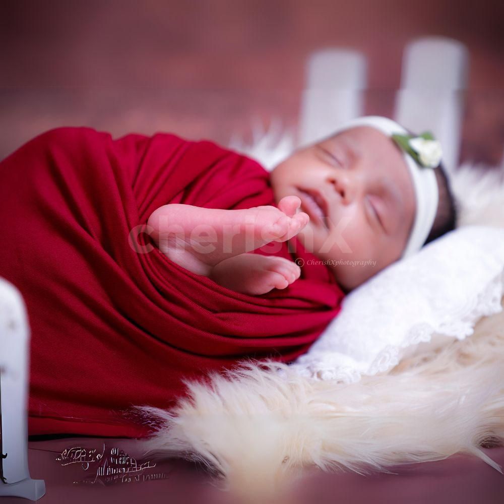 Charming Delight: Baby’s joyful expression in a beautifully styled scene
