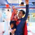 Superman celebrating the cake-cutting ceremony