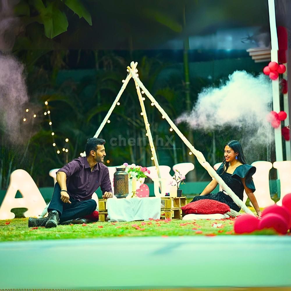 Proposal Magic - Heart-shaped balloon decor and "Will You Marry Me" neon light create a stunning backdrop.