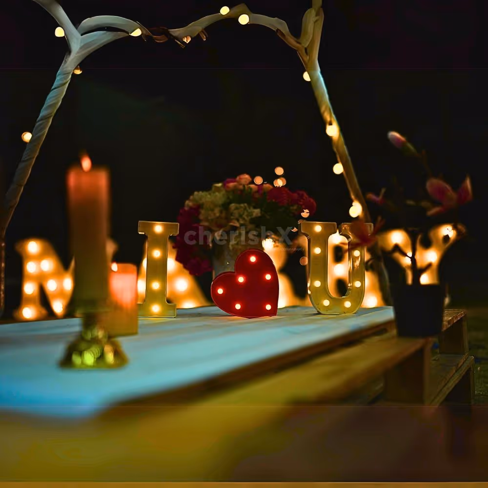 Candlelit "I Love You" and heart-shaped rose petal decoration for a magical touch