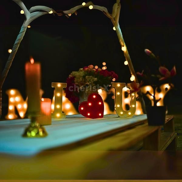 Candlelit "I Love You" and heart-shaped rose petal decoration for a magical touch