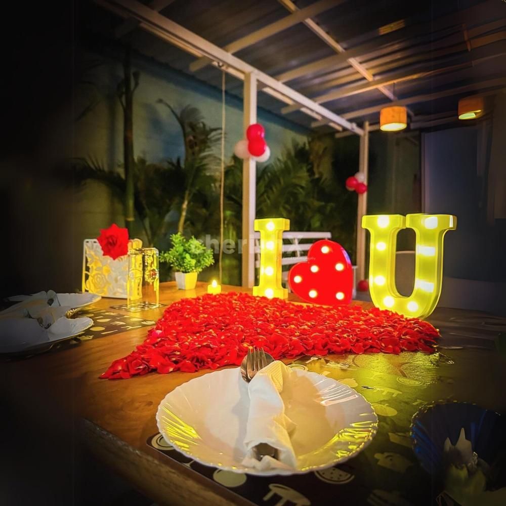 Romantic Centerpiece - Candlelit "I Love You" and heart-shaped rose petal decoration for a magical touch.