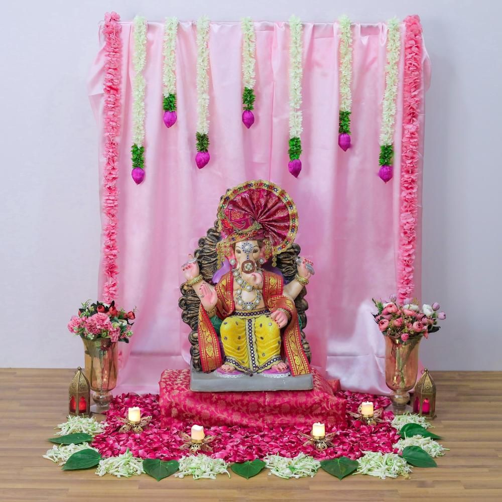 Pink Ganpati decoration with artificial flowers