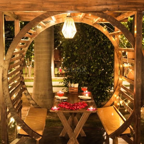 Vibrant Table Setup – A beautifully decorated table with candles and flower petals awaits.