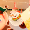 Twinkle lights and paper cutouts make for a cozy holiday ceiling