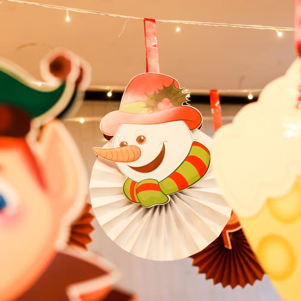 Twinkle lights and paper cutouts make for a cozy holiday ceiling