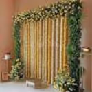 A beautiful marigold floral backdrop adds a vibrant and elegant touch to the celebration.