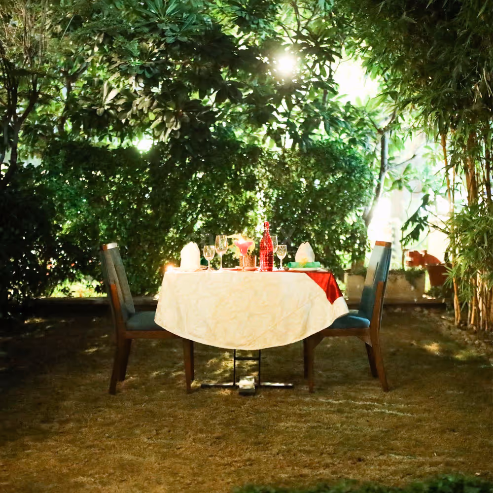 A beautifully decorated table amidst lush greenery, perfect for two.