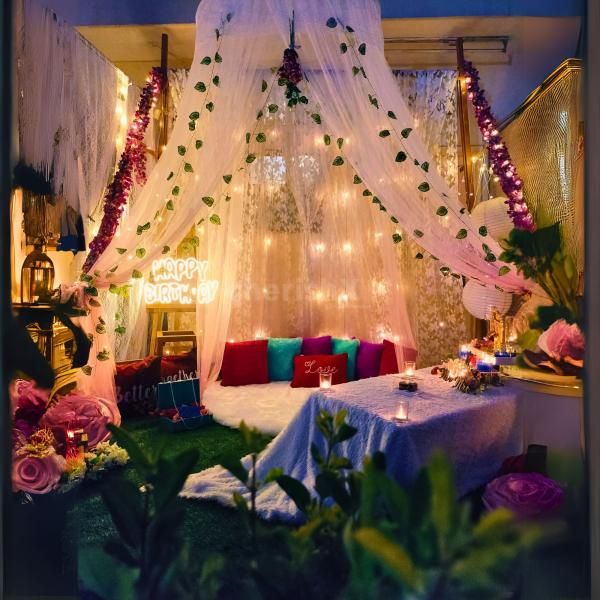 Indulge in a magical evening with a cozy canopy setup and gourmet delights