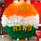 A patriotic reception area featuring flags, doves, and an Ashoka Chakra.
