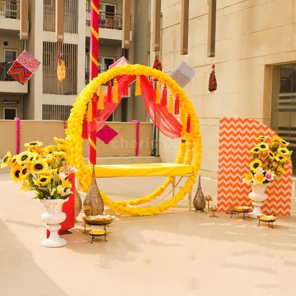 Dazzle your Haldi Mehndi with the beautiful yellow ring decor setup.