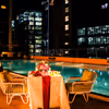 Enjoy a serene poolside setting with candlelight and flower decorations.