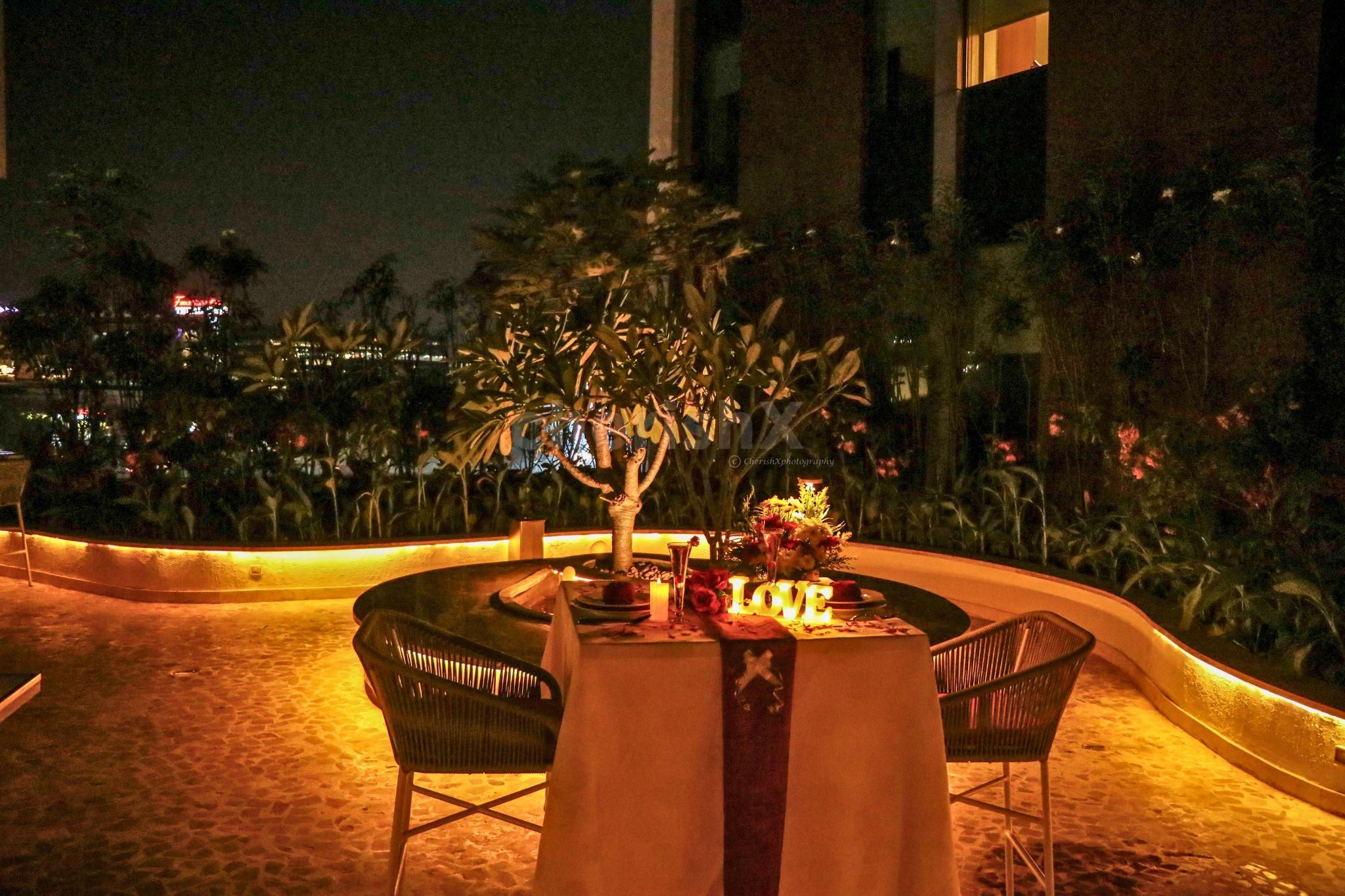 Romantic ambiance with flower decorations and glowing candlelights.