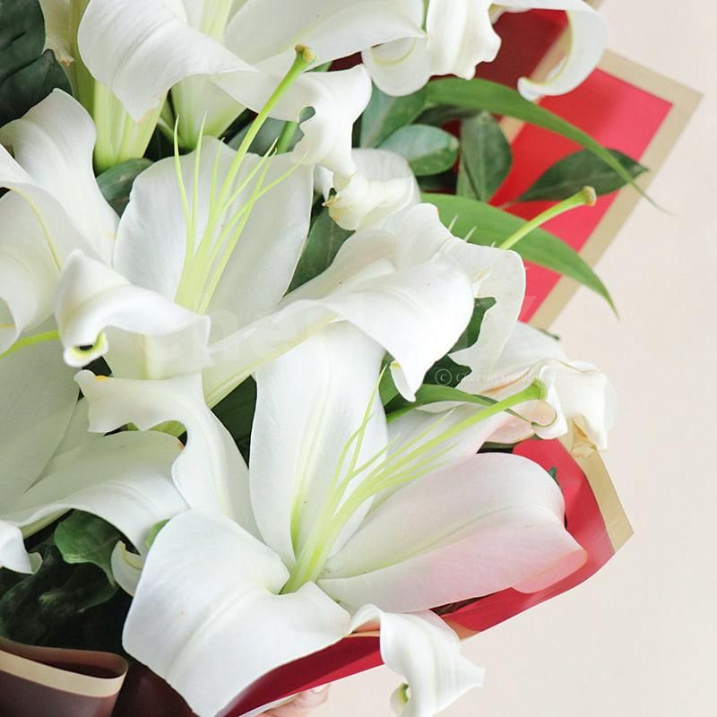 This elegant arrangement consists of four radiant white lilies