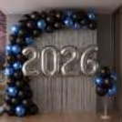 Balloon stand and sticks complement the wall decor with a ground-level balloon cluster