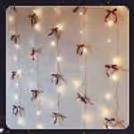 Wall decor with fairy lights and handmade bows
