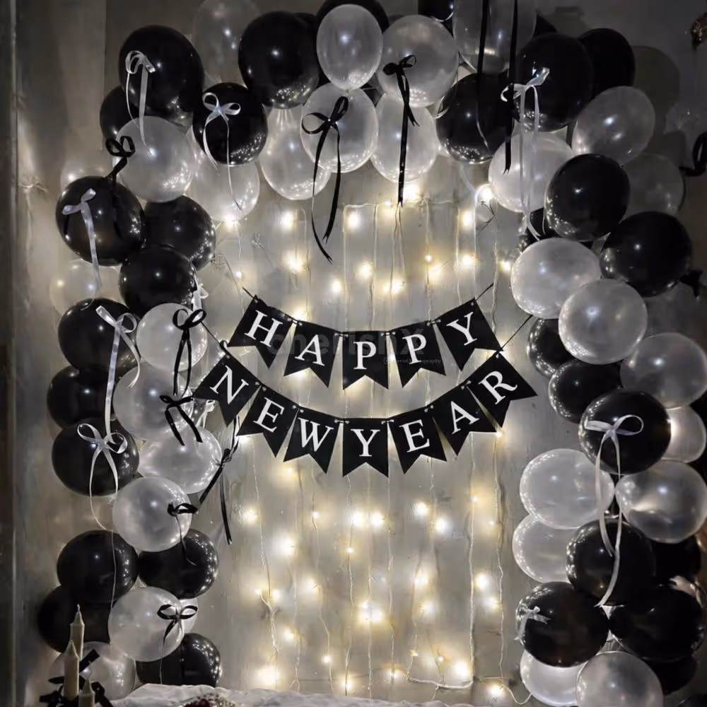 An alternative metallic white and black balloon arch creates a chess-like pattern on the wall.